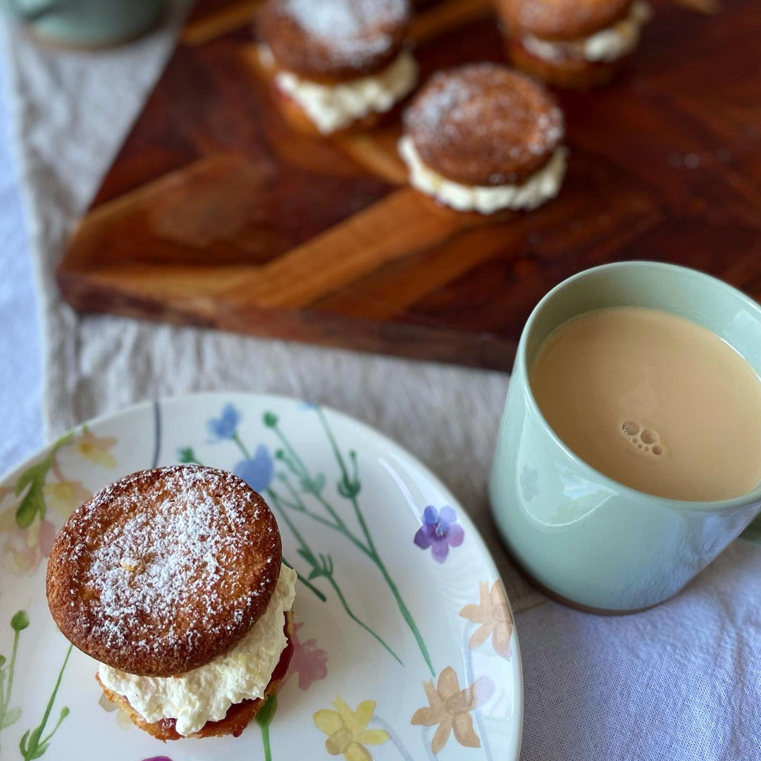 keto friendly vanilla whoopie pie with cream filling on a plate with a cup of coffee